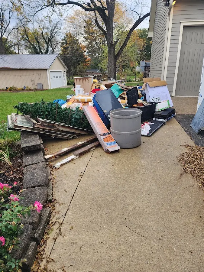 Dumpster being loaded with debris for Demolition Dumpster Rental in Chippewa Falls